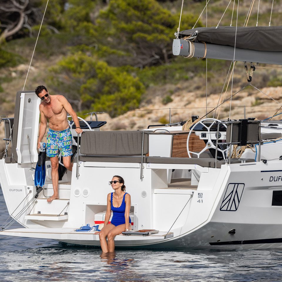 Couple on swim platform of the Dufour 41 sailing boat