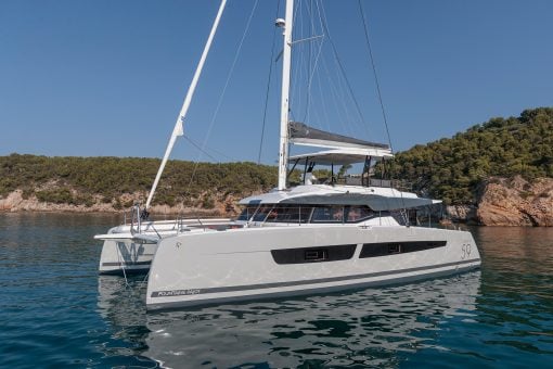 Fountaine Pajot Samana 59 yacht at anchor near coastline
