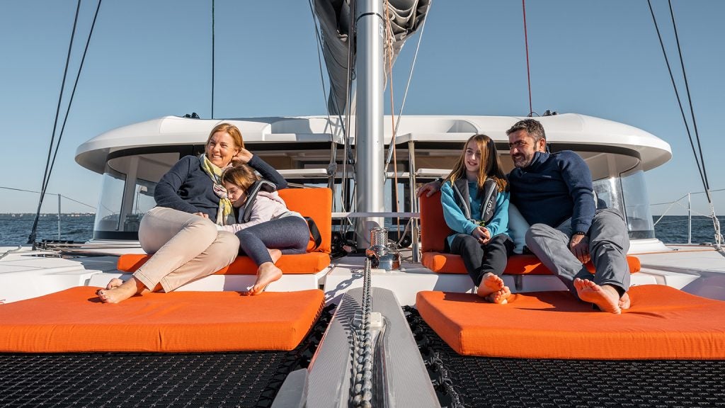Family enjoying front deck of Excess 14 sailing catamaran