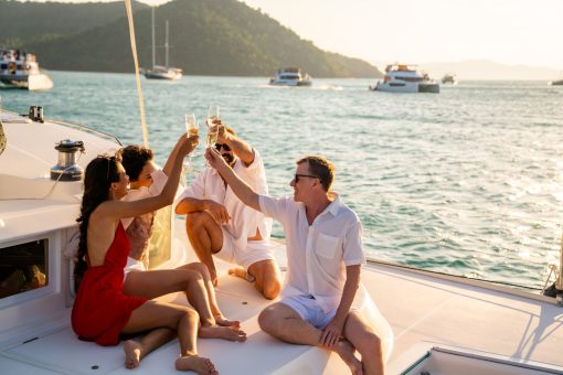 Group of friends enjoying on a catamaran at anchor.