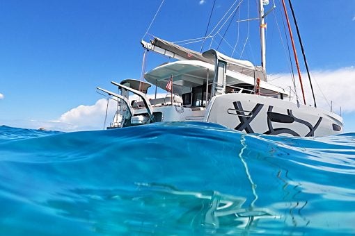 Exterior of the Excess 14 anchored in blue water