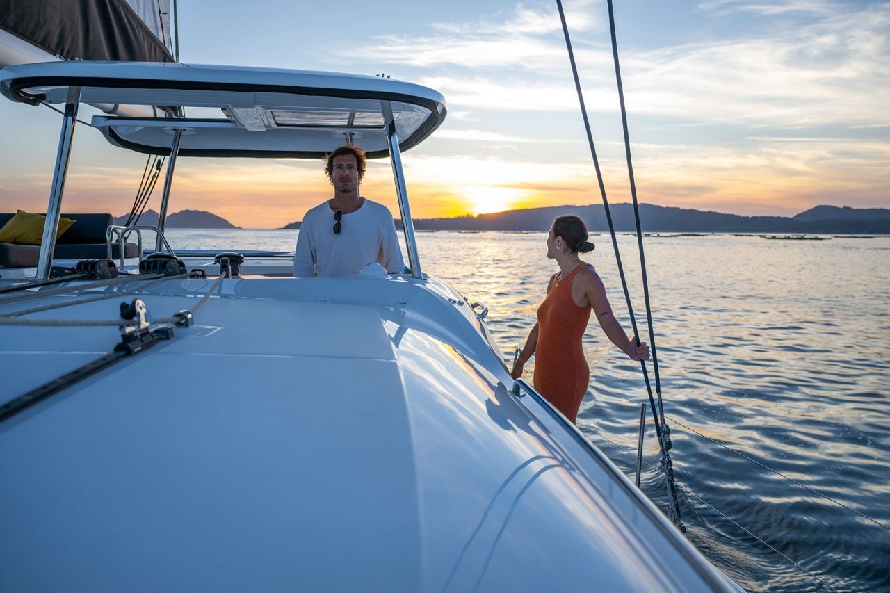 Man at helm of a Lagoon 43 catamaran