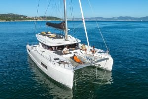 Group of people lounging on foredeck of a Lagoon catamaran