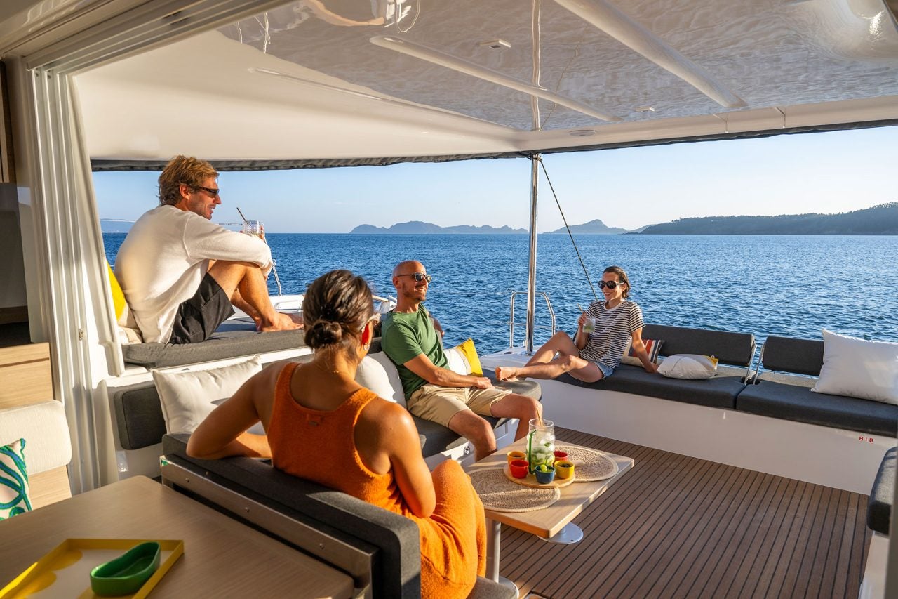 Group of friends lounging in cockpit of a Lagoon 43 catamaran