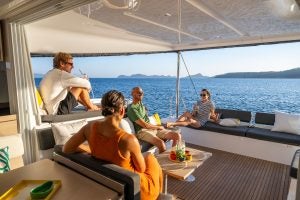 Group of friends lounging in cockpit of a Lagoon 43 catamaran