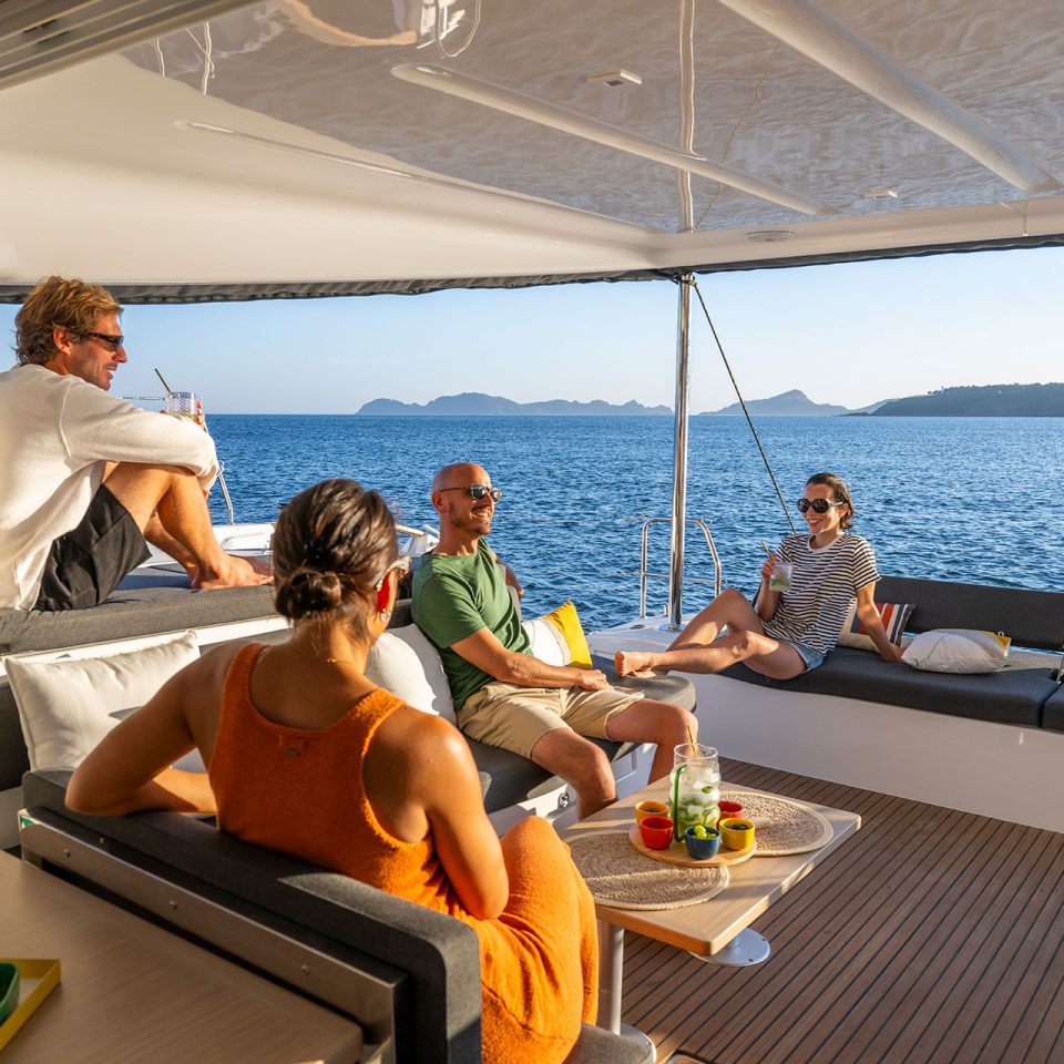 Group of friends lounging in cockpit of a Lagoon 43 catamaran