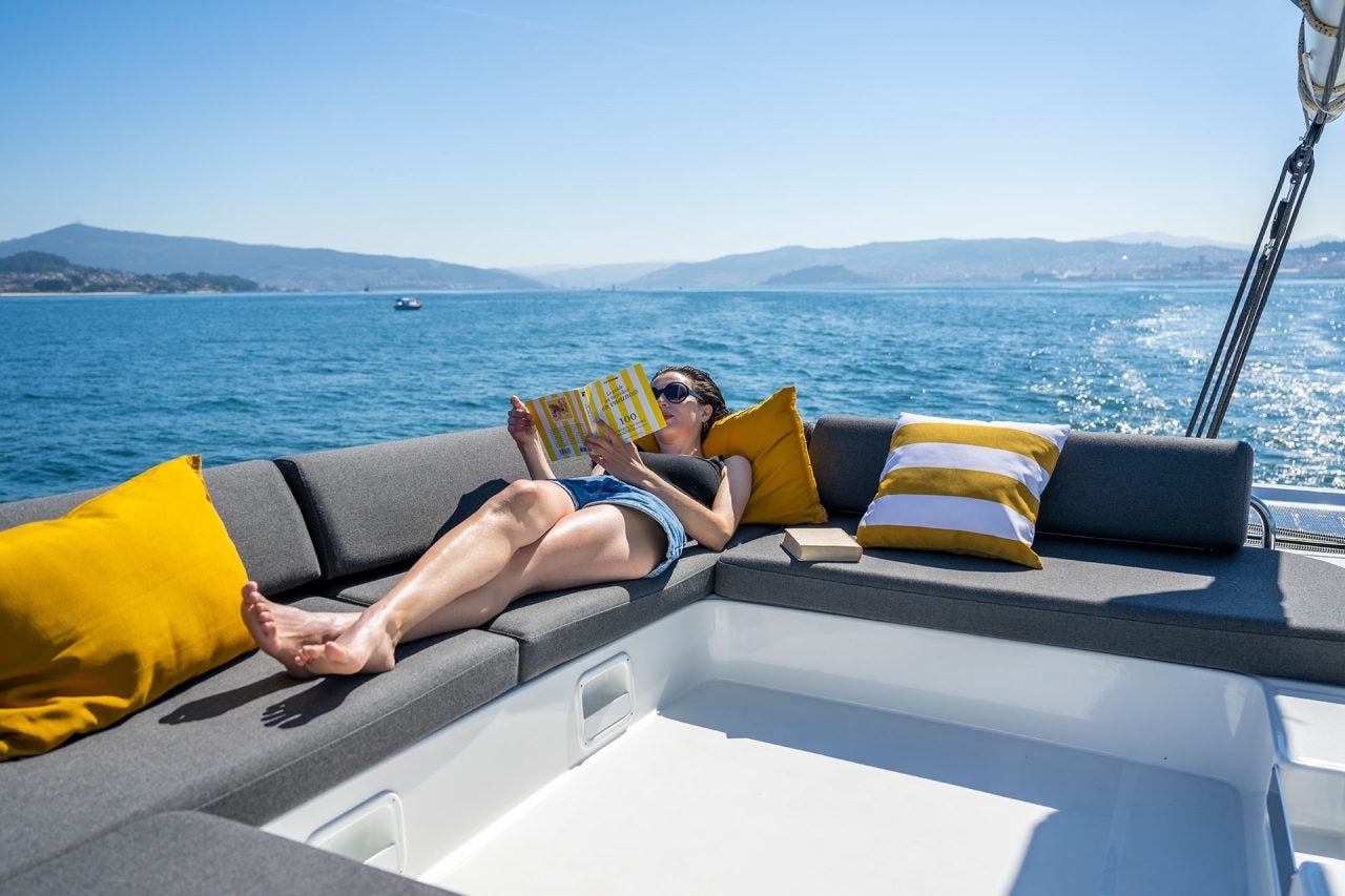 Woman lounging on the flybridgee of a Lagoon 43 sailboat