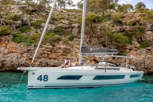 Side view of the Dufour 48 sailing yacht at anchor