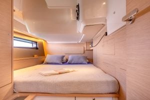 Interior cabin bed onboard the Dufour 48 sailing yacht