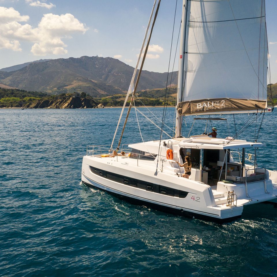 Bali 4.2 yacht sailing with green mountains in distance